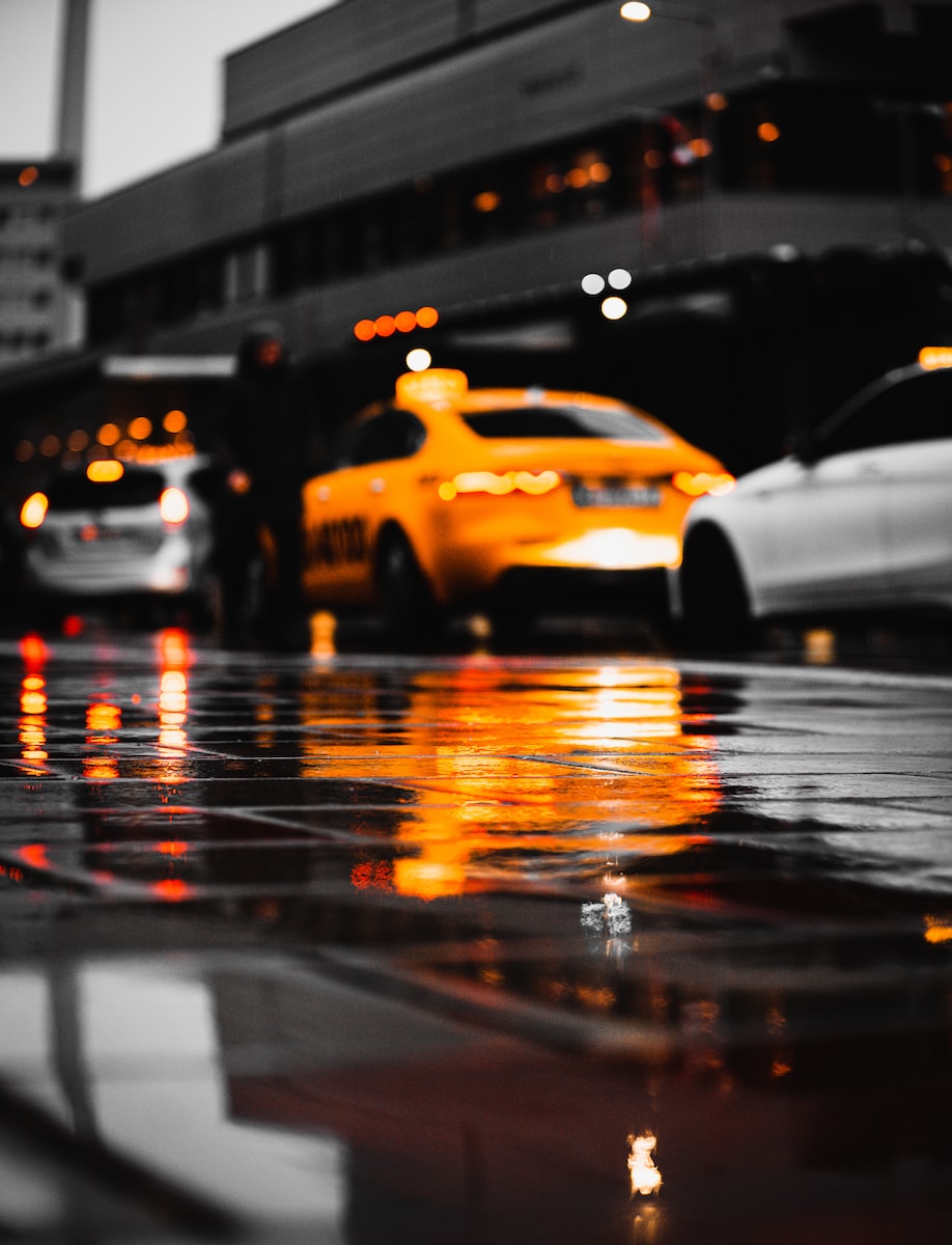 yellow taxi cab on road during night time